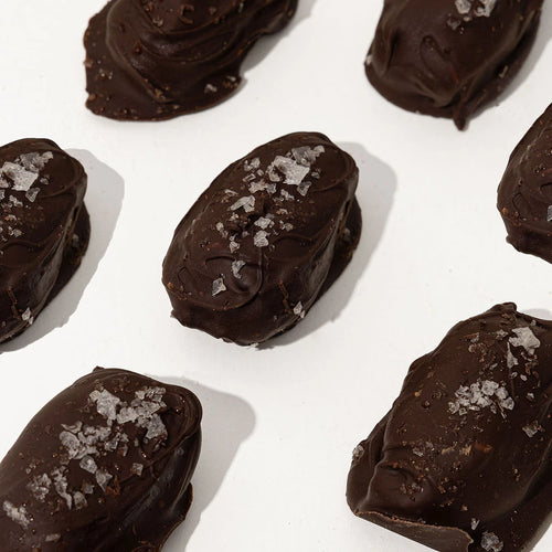 Chocolate truffles with sea salt on a white background